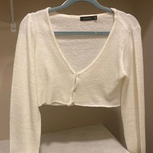 Cropped white sweater with pearl button front